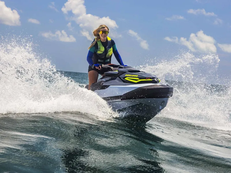 Slide: The Image of 2024 Sea-Doo RXT-X 325 Tech Package jet ski on ocean waves, sunny day. - 11