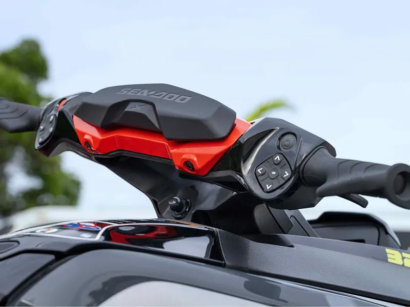 Slide: The Image of 2024 Sea-Doo RXT-X 325 Tech Package handlebars with control buttons, close-up view. - 6