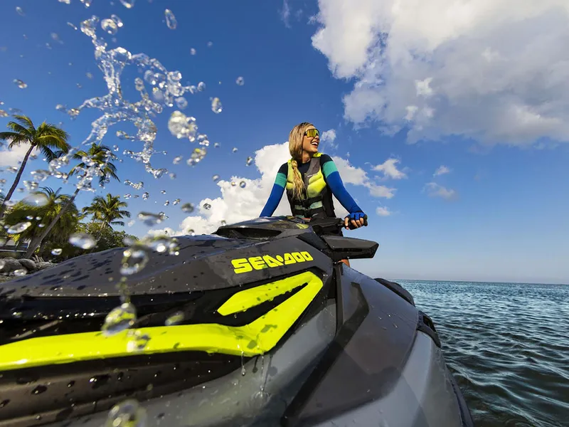 Slide: The Image of 2024 Sea-Doo RXT-X 325 Tech Package on water, rider enjoying sunny day. - 8