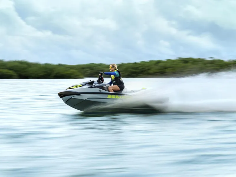 Slide: The Image of 2024 Sea-Doo RXT-X 325 Tech Package jet ski speeding on water. - 9