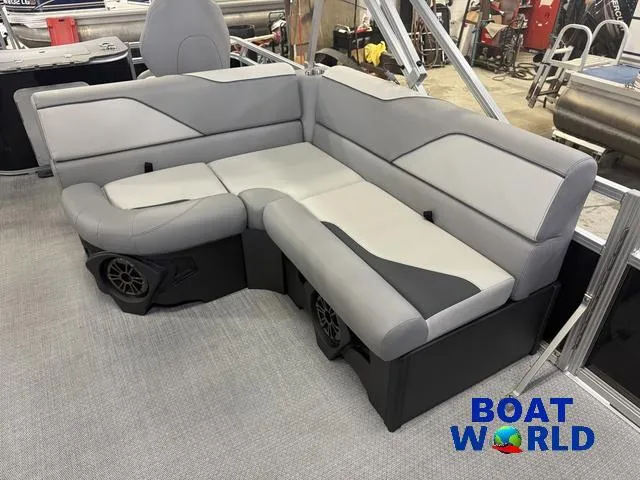 Slide: The Image of 2025 Tahoe Sport 2185 boat interior with gray seating and speakers, showcased at Boat World. - 10