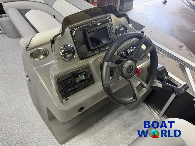 Slide: The Image of 2025 Tahoe Sport 2185 boat dashboard with steering wheel and controls. - 13