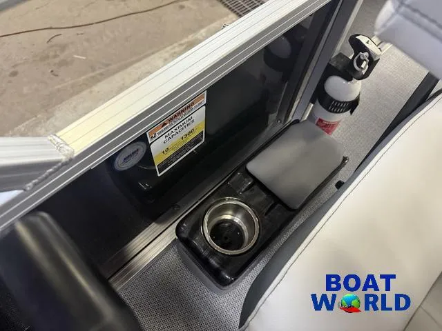 Slide: The Image of 2025 Tahoe Sport 2185 boat interior with cup holder and fire extinguisher, Boat World logo. - 16