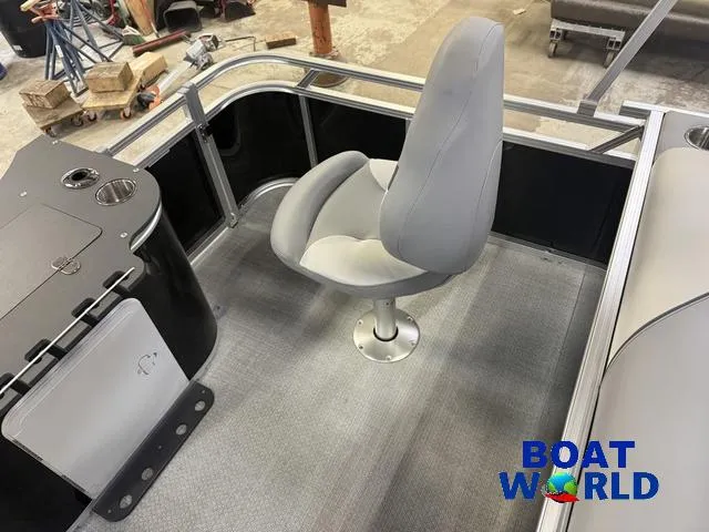 Slide: The Image of 2025 Tahoe Sport 2185 boat interior with swivel seat and console, featuring Boat World logo. - 18