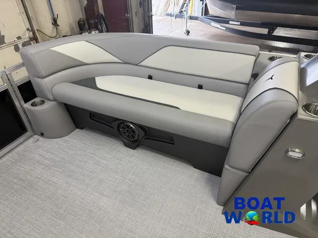 Slide: The Image of 2025 Tahoe Sport 2185 boat interior with gray seating and speaker, branded "Boat World." - 27