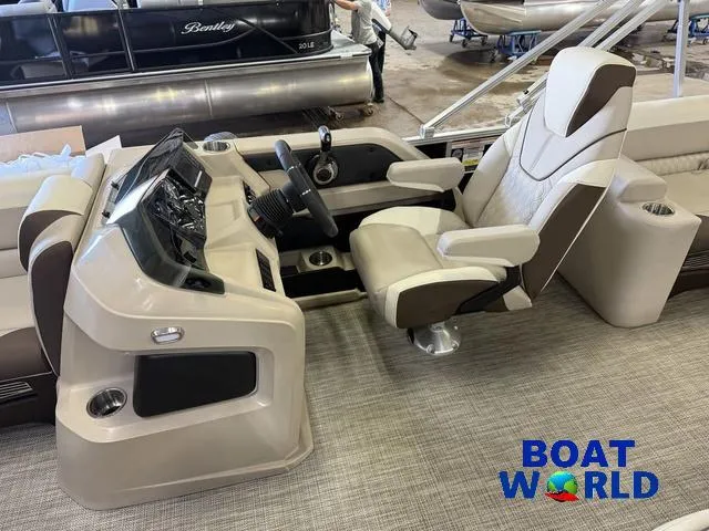Slide: The Image of 2025 Tahoe LTZ 2385 Elite Cruise boat interior with modern helm and comfortable captain's chair. - 11