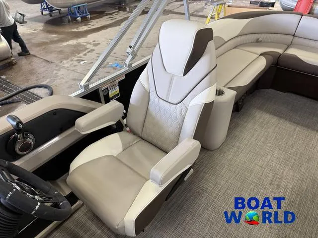 Slide: The Image of 2025 Tahoe LTZ 2385 Elite Cruise interior with luxury seating and steering, showcased by Boat World. - 12