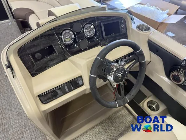 Slide: The Image of 2025 Tahoe LTZ 2385 Elite Cruise dashboard with modern steering and controls, showcased by Boat World. - 13