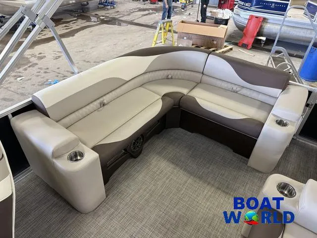 Slide: The Image of 2025 Tahoe LTZ 2385 Elite Cruise boat interior with plush seating and cup holders. - 20