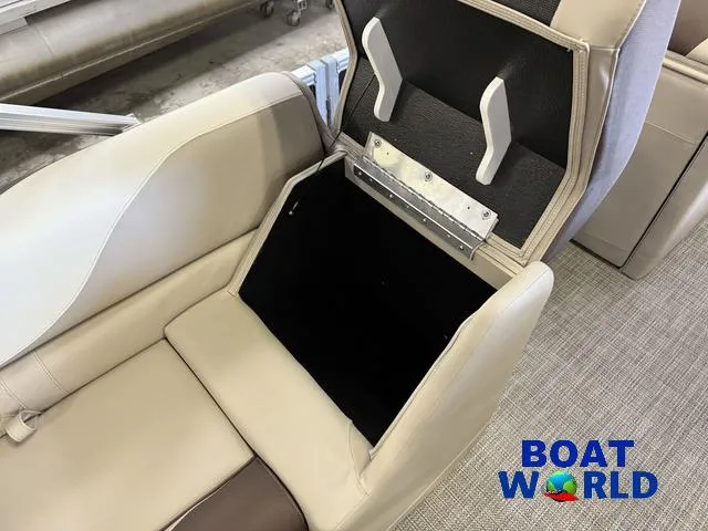 Slide: The Image of 2025 Tahoe LTZ 2385 Elite Cruise seat storage compartment, open, with beige upholstery. - 23