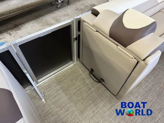 Slide: The Image of 2025 Tahoe LTZ 2385 Elite Cruise interior seating with storage compartment, featuring beige and brown upholstery. - 24