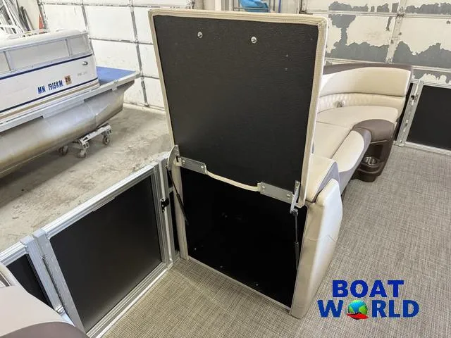 Slide: The Image of 2025 Tahoe LTZ 2385 Elite Cruise interior with open storage compartment, showcasing luxury seating. - 25