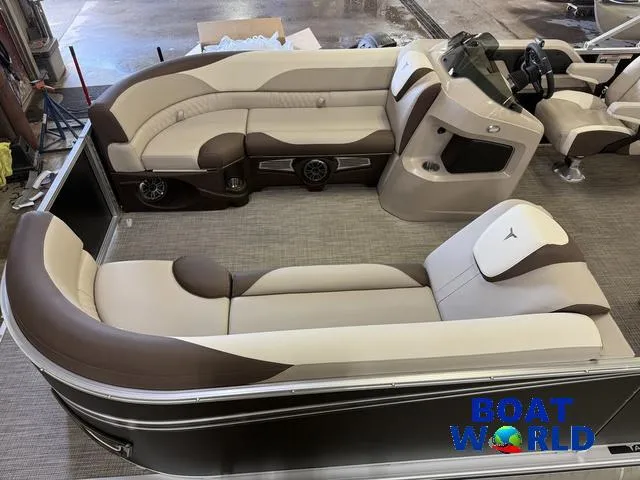 Slide: The Image of 2025 Tahoe LTZ 2385 Elite Cruise interior with beige and brown seating, showcased at Boat World. - 3