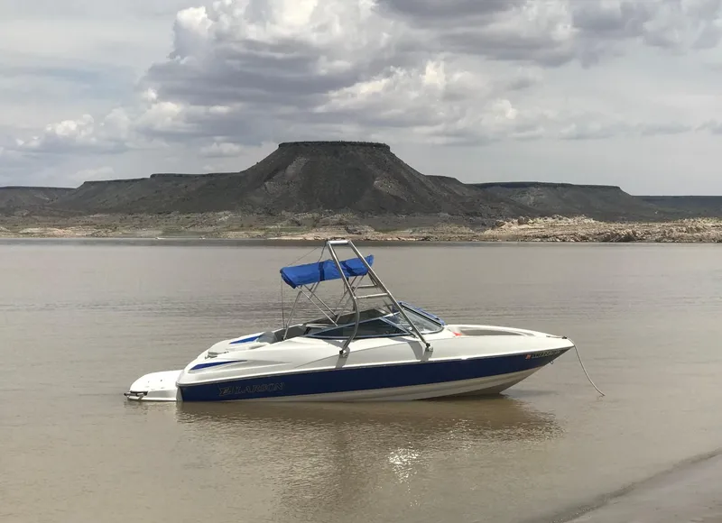 Slide: The Image of 2006 Larson 186 SENZA boat on calm lake with mountainous backdrop. - 14
