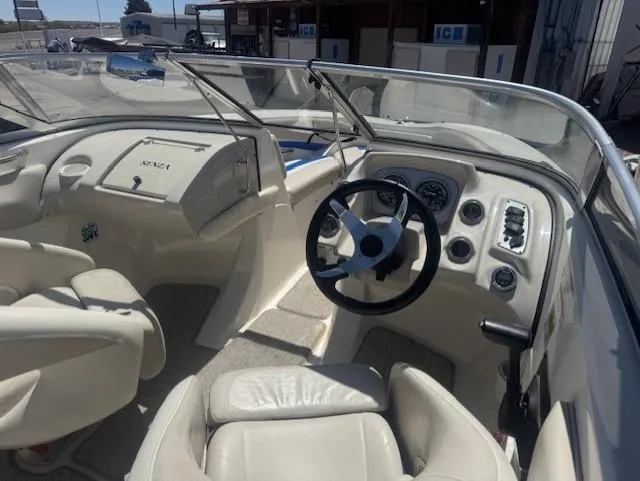 Slide: The Image of Interior of a 2006 Larson 186 SENZA boat, featuring steering wheel and dashboard controls. - 5
