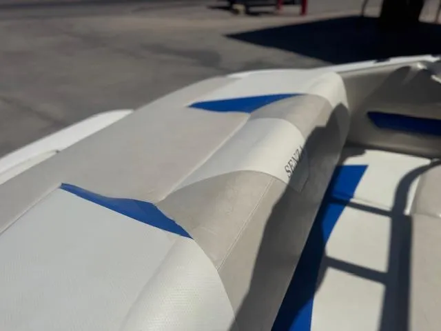 Slide: The Image of 2006 Larson 186 SENZA boat interior with blue and white upholstery details. - 8