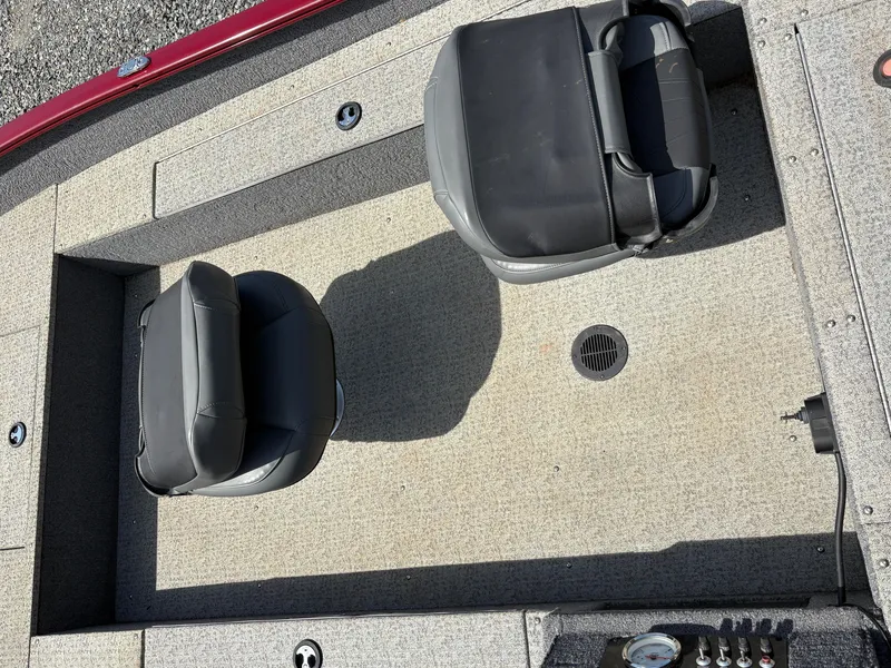Slide: The Image of 2021 Tracker Super Guide V-16 T boat interior with two black seats on a textured floor. - 11