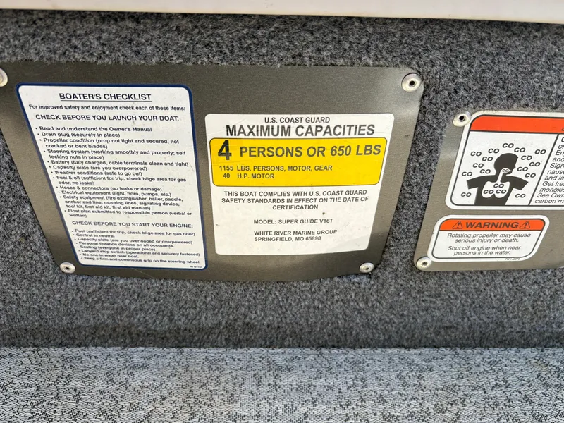 Slide: The Image of 2021 Tracker Super Guide V-16 T capacity plate, showing 4-person or 650 lbs limit. - 13
