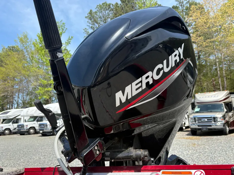 Slide: The Image of Mercury outboard motor on 2021 Tracker Super Guide V-16 T boat, parked outdoors. - 15