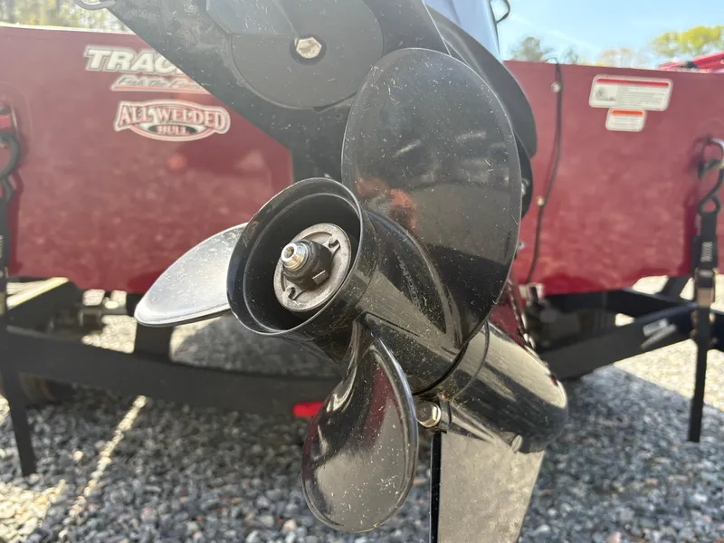 Slide: The Image of Propeller of 2021 Tracker Super Guide V-16 T boat on gravel surface. - 16