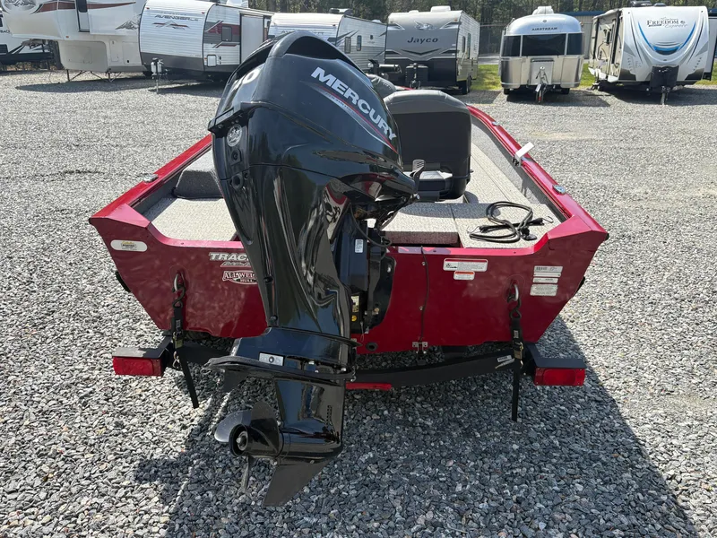 Slide: The Image of 2021 Tracker Super Guide V-16 T boat with Mercury outboard motor, parked on gravel. - 5
