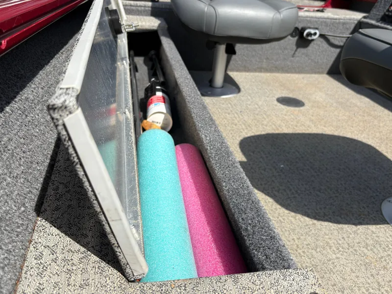 Slide: The Image of 2021 Tracker Super Guide V-16 T boat storage with pool noodles and fire extinguisher. - 6