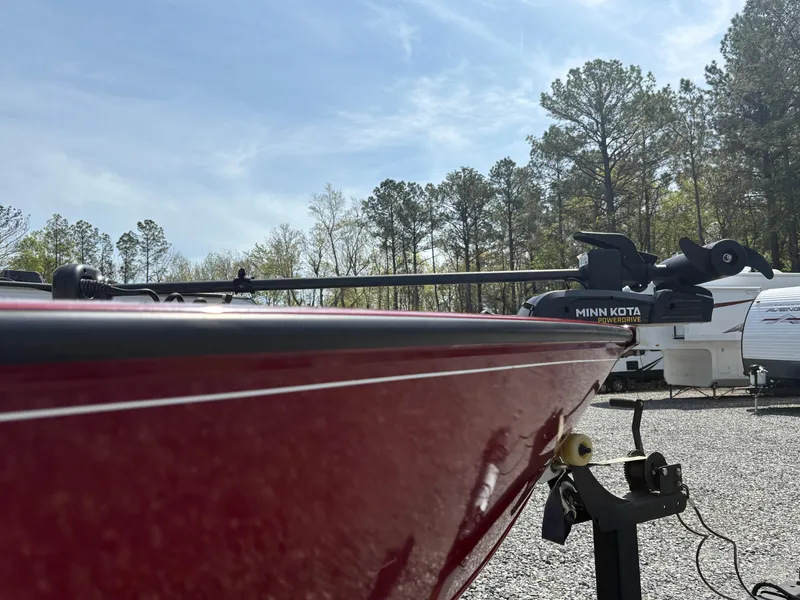 Slide: The Image of 2021 Tracker Super Guide V-16 T boat with Minn Kota motor, parked outdoors. - 7