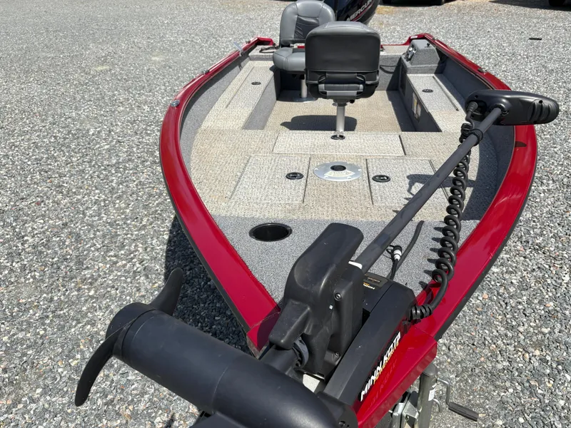 Slide: The Image of 2021 Tracker Super Guide V-16 T fishing boat with red exterior and trolling motor. - 8