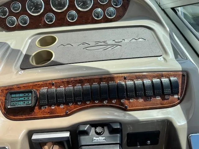 Slide: The Image of Dashboard of a 2001 Maxum 3500 SCR boat with gauges and control switches. - 12