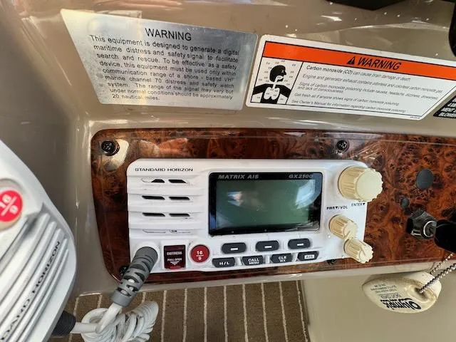 Slide: The Image of 2001 Maxum 3500 SCR boat radio panel with safety warnings and controls. - 14