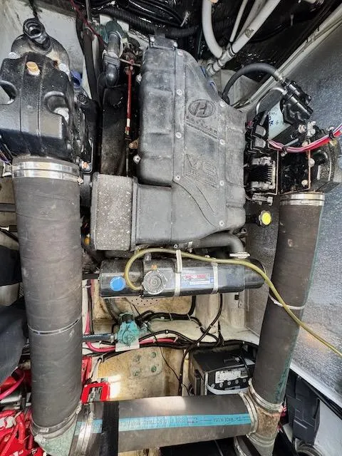 Slide: The Image of Engine compartment of a 2001 Maxum 3500 SCR boat, showcasing mechanical components and wiring. - 21