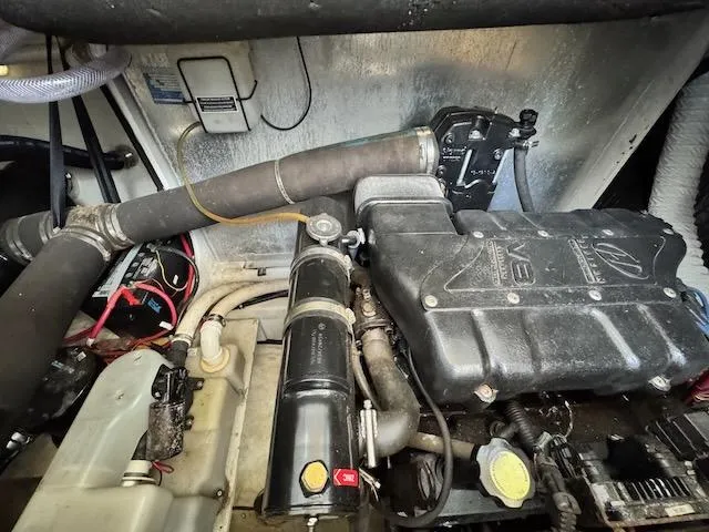 Slide: The Image of Engine compartment of a 2001 Maxum 3500 SCR boat, showcasing mechanical components and wiring. - 22