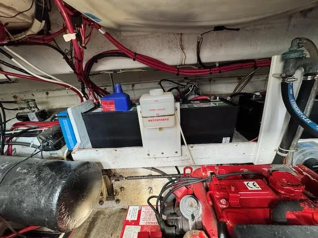 Slide: The Image of Engine compartment of a 2001 Maxum 3500 SCR boat, featuring wiring and mechanical components. - 28