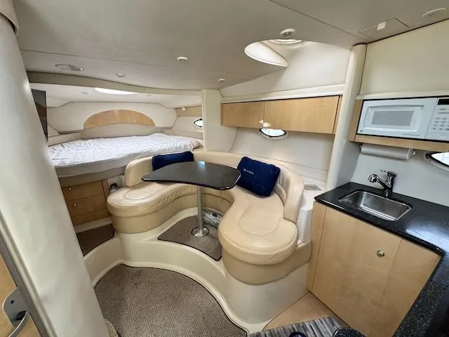 Slide: The Image of 2001 Maxum 3500 SCR yacht interior with cozy seating, kitchenette, and bed. - 30
