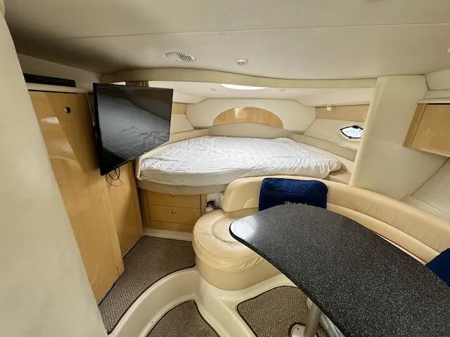 Slide: The Image of Interior of 2001 Maxum 3500 SCR yacht with bed, TV, and seating area. - 32