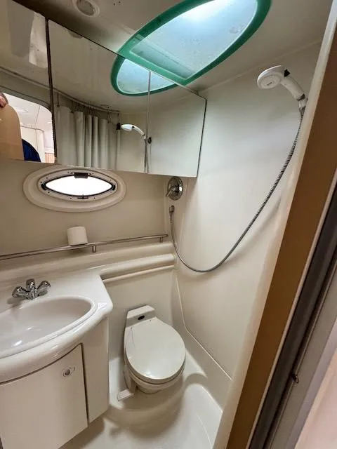 Slide: The Image of Compact bathroom in 2001 Maxum 3500 SCR boat with shower, sink, and toilet. - 36