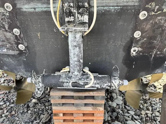 Slide: The Image of 2001 Maxum 3500 SCR boat hull with propellers and rudder on wooden blocks. - 45