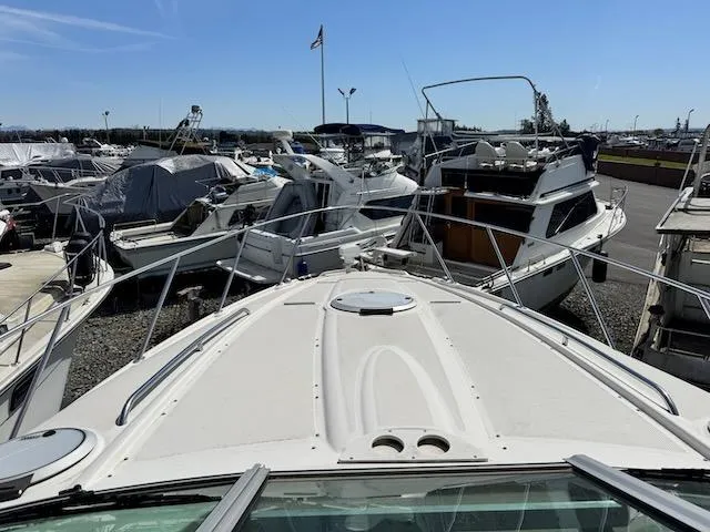 Slide: The Image of 2001 Maxum 3500 SCR boat docked among other vessels under a clear blue sky. - 47