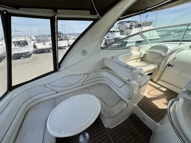 Slide: The Image of 2001 Maxum 3500 SCR yacht interior with white seating and round table. - 5