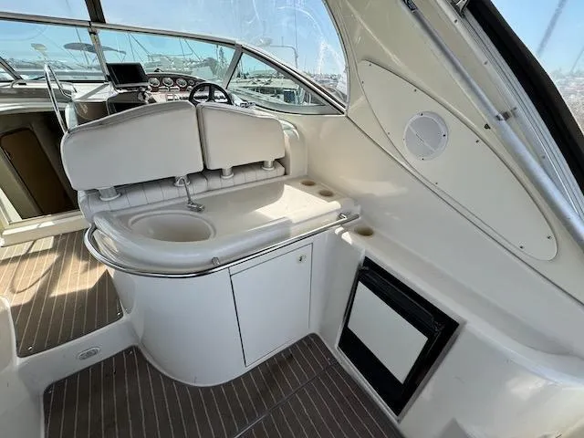 Slide: The Image of 2001 Maxum 3500 SCR yacht interior with helm, sink, and seating area. - 7
