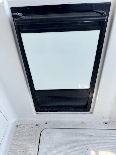 Slide: The Image of Boat hatch on 2001 Maxum 3500 SCR, featuring a black frame and white panel. - 8