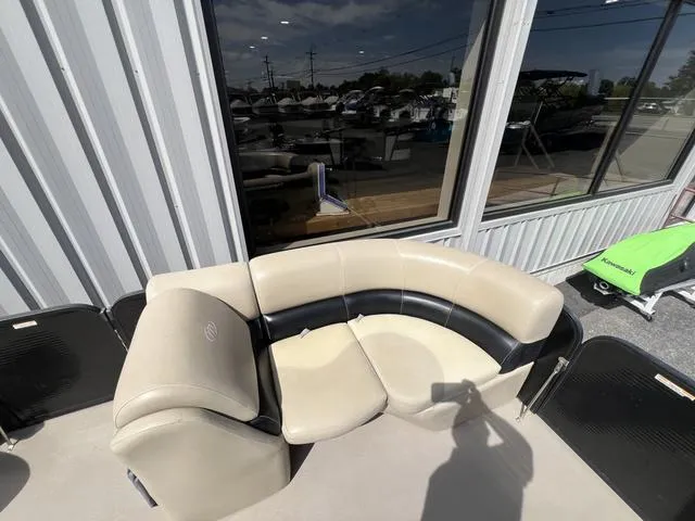 Slide: The Image of 2021 Manitou 23 Aurora LE VP boat seating area with beige and black upholstery. - 11