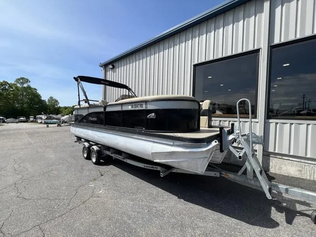 Slide: The Image of 2021 Manitou 23 Aurora LE VP pontoon boat on trailer outside a building. - 4