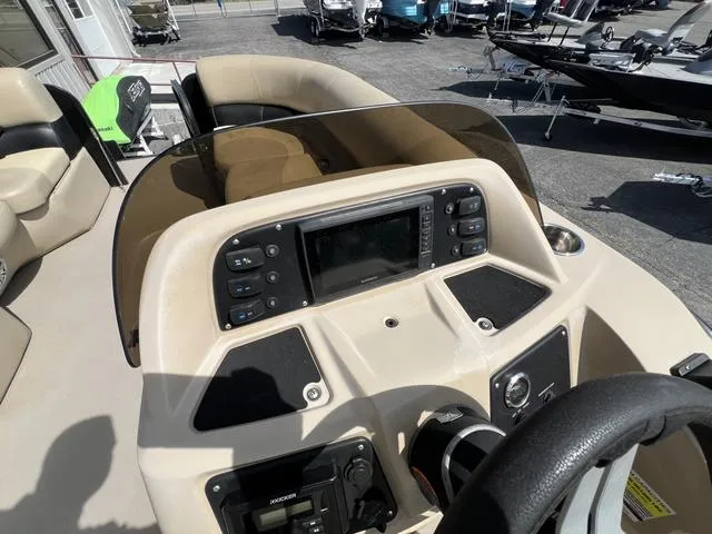 Slide: The Image of 2021 Manitou 23 Aurora LE VP boat dashboard with steering wheel and control panel. - 8