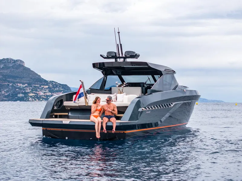 Slide: The Image of 2023 Bekkers Yachts Azur 45HT cruising with two people on deck, scenic coastal backdrop. - 10