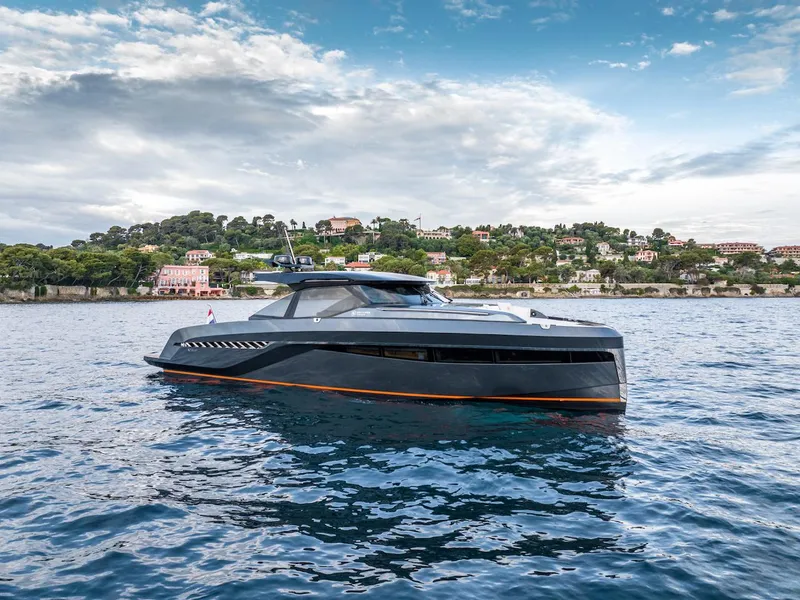 Slide: The Image of 2023 Bekkers Yachts Azur 45HT cruising on serene waters with scenic coastal backdrop. - 11