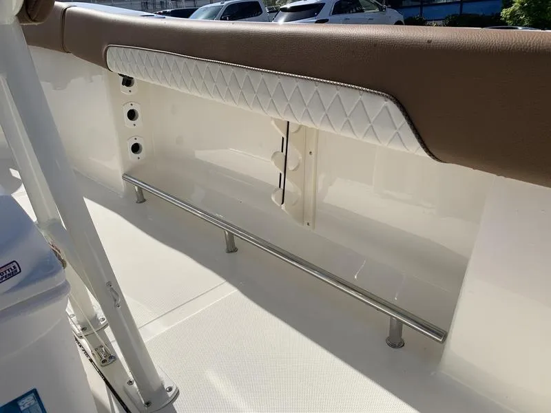 Slide: The Image of 2025 Pioneer ISLANDER 202 boat interior with cushioned seating and stainless steel railing. - 14