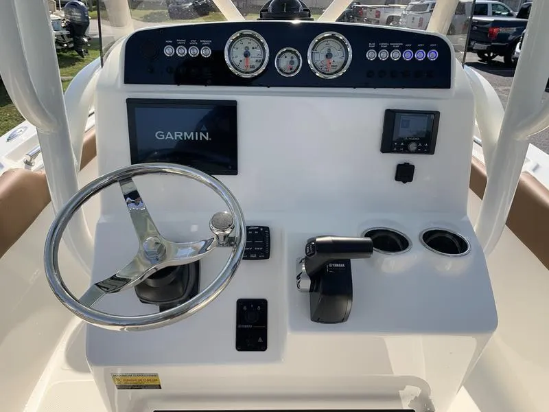 Slide: The Image of 2025 Pioneer ISLANDER 202 boat dashboard with Garmin display and Yamaha controls. - 18