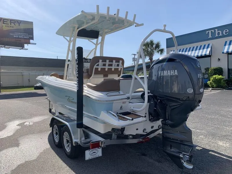 Slide: The Image of 2025 Pioneer ISLANDER 202 boat with Yamaha engine on a trailer. - 2