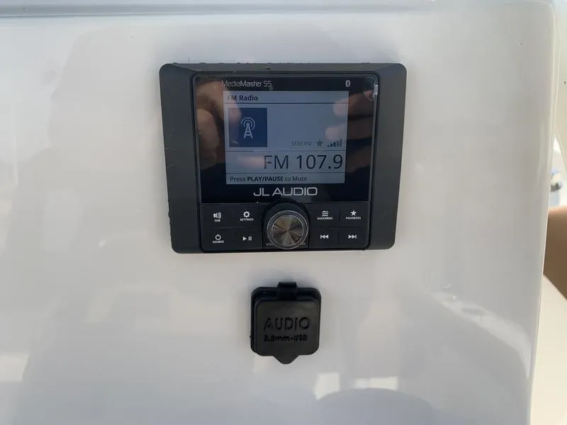 Slide: The Image of JL Audio system on Pioneer ISLANDER 202 boat, displaying FM 107.9 radio station. - 20